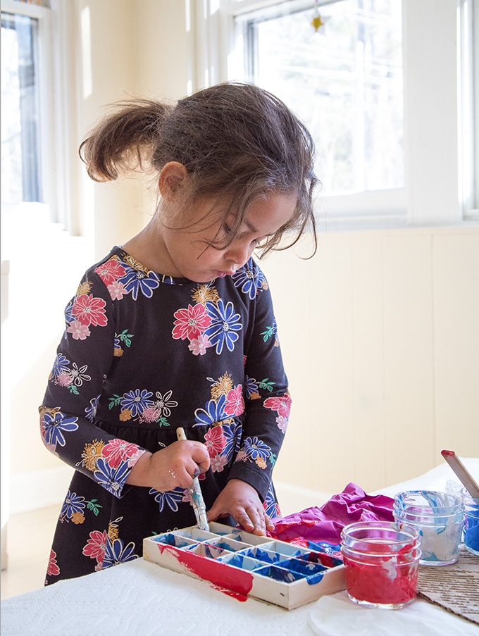 Child painting wooden box