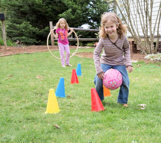 children playing in backyard obstacle course