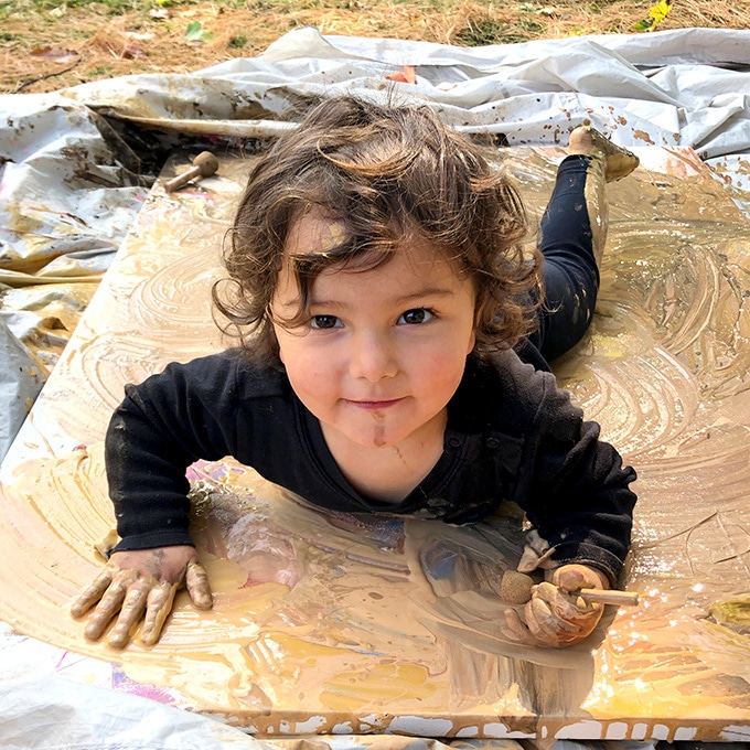 Toddler painting on canvas